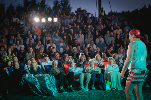Spektakl Powarkiwania Drogi Mlecznej, aktor stoi przed licznie zgromadzoną publicznością
