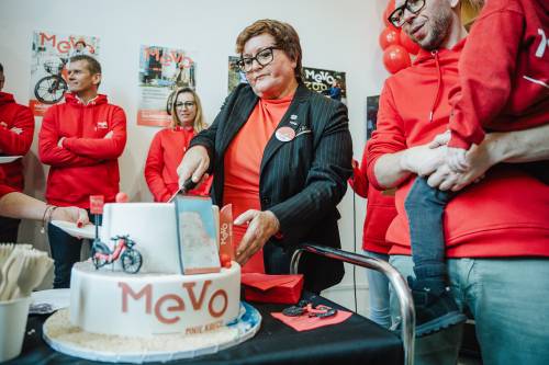 Uroczystość, czerwone stroje, kobieta kroi tort.