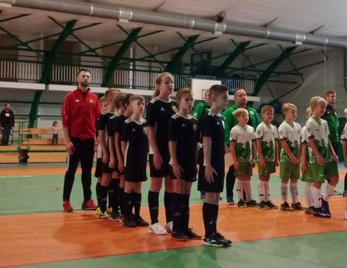 Zdjęcie przedstawia mecz rozgrywany podczas halowego turnieju piłki nożnej